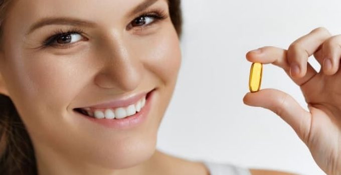 Vitamins. Healthy Eating. Close Up Of Happy Beautiful Girl With Pill With Cod Liver Oil Omega-3. Nutrition. Healthy Lifestyle. Nutritional Supplements. Sport, Diet Concept. Vitamin D, E, A Fish Oil Capsules.